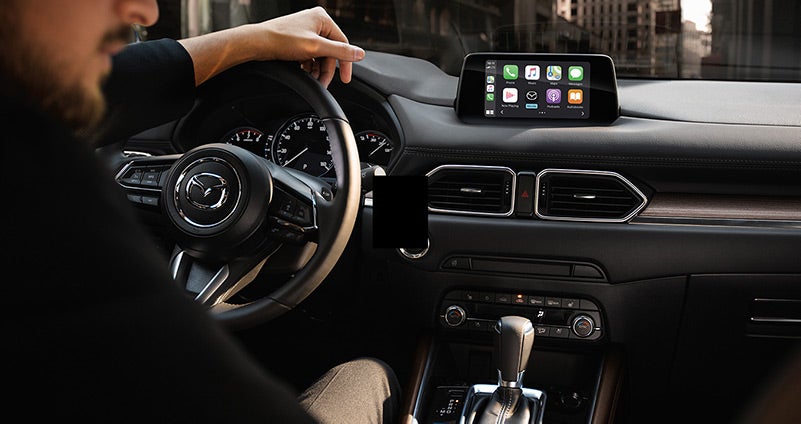 Man driving a 2020 Mazda CX-5 with black leather interior | Open Road Mazda of Morristown in Morristown, NJ